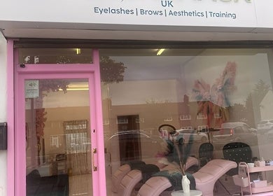 Lashesbychance salon exterior in Romford, England, showcasing a pink-framed entrance and stylish interior.