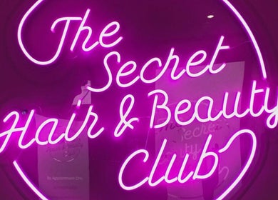 Vibrant neon sign at Megan Eve Hair, Hinckley, England, GB, showcasing beauty club allure.