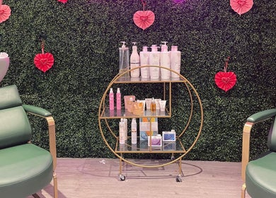 Chic salon setup at Megan Eve Hair in Hinckley, England, GB, with elegant chairs and a product display.