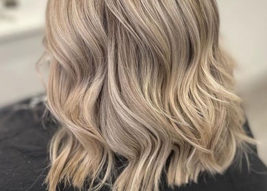 Elegant blonde waves styled at Megan Eve Hair, located in Hinckley, England, GB.