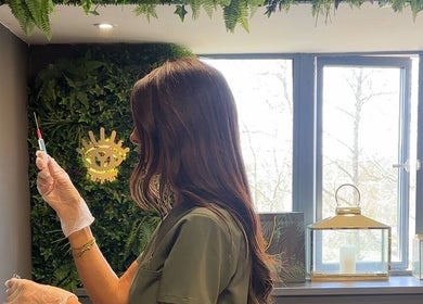 Aesthetician prepares a treatment in the lush interior of Yugen Skin Clinic, Sandbach, England, GB.