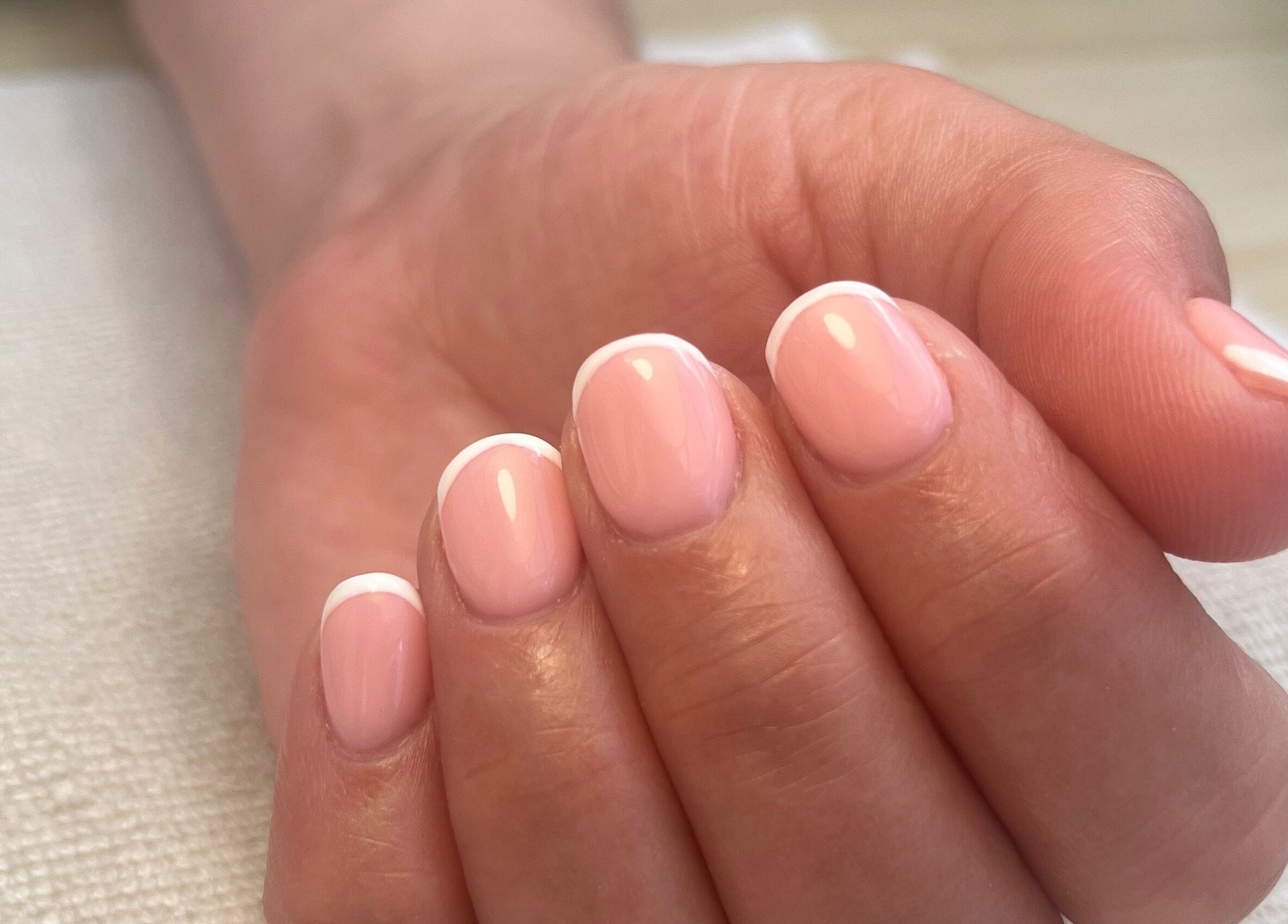 Elegant French manicure at Polished by Megan, Ashington, England, GB, showcasing delicate pink and white nails.