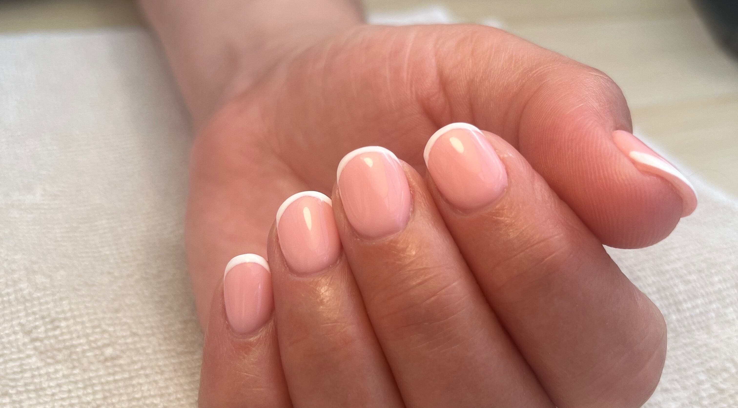 Elegant French manicure at Polished by Megan, Ashington, England, GB, showcasing delicate pink and white nails.
