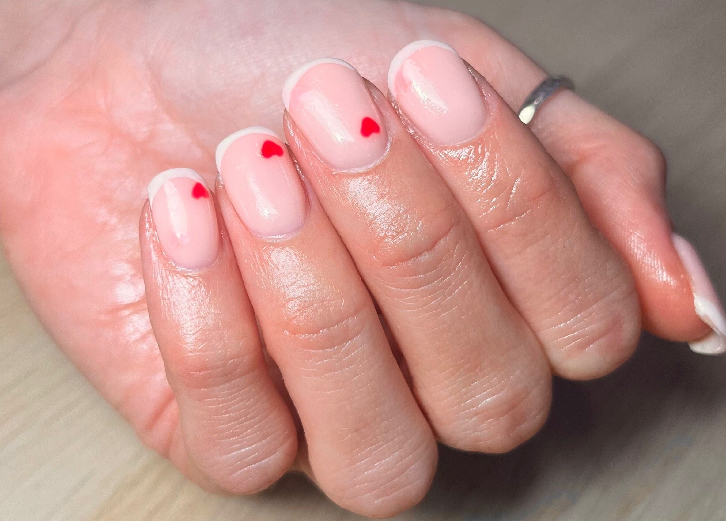 Elegant manicure with red heart tips at Polished by Megan, Ashington, England, GB.