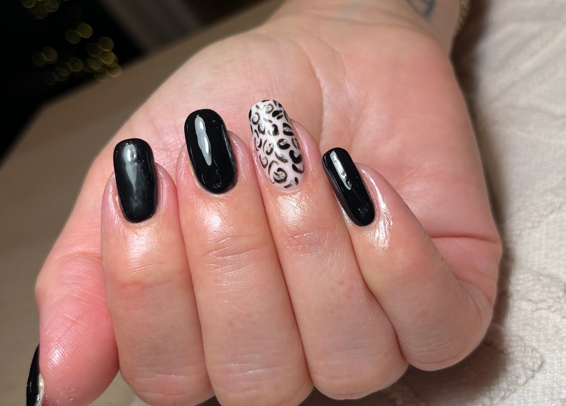 Elegant black nails with leopard accent by Polished by Megan in Ashington, England, GB.