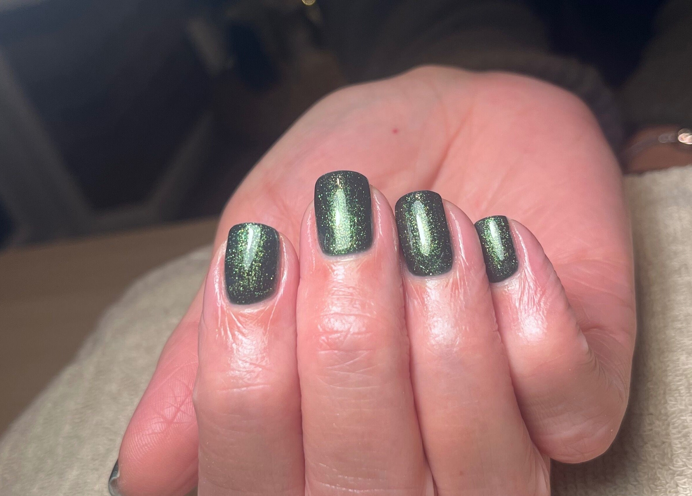 Glistening emerald nails at Polished by Megan, Ashington, England. Luxurious manicure experience.