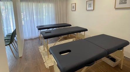 Therapy room featuring massage tables at Your Healing Hub & Abiding Body Wellness, Helensvale, Queensland, AU.