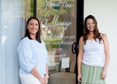 Two women smiling at Your Healing Hub & Abiding Body Wellness entrance in Helensvale, Queensland, AU.