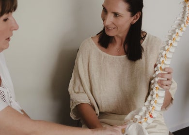 Consultation at Your Healing Hub & Abiding Body Wellness, Helensvale, Queensland, AU showing spine model.