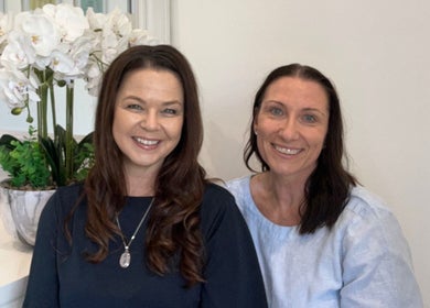 Two smiling women at Your Healing Hub & Abiding Body Wellness, Helensvale, Queensland, AU, enhancing warmth.