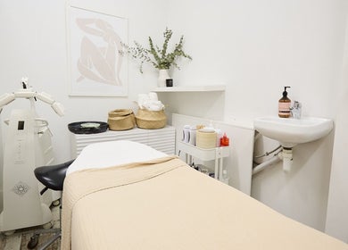 Cozy spa room at Parlour Box, North Bondi, New South Wales, AU, with treatment bed and skincare equipment.