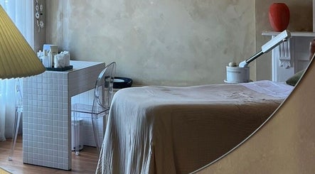 Cozy treatment room at Parlour Box, Bondi, New South Wales, AU, featuring a massage table and soft lighting.