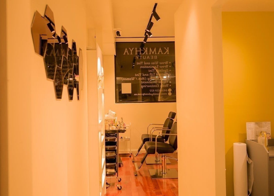 Interior of Kamkhya Beauty, Subiaco, Western Australia, AU, featuring chic chairs and ambient lighting.