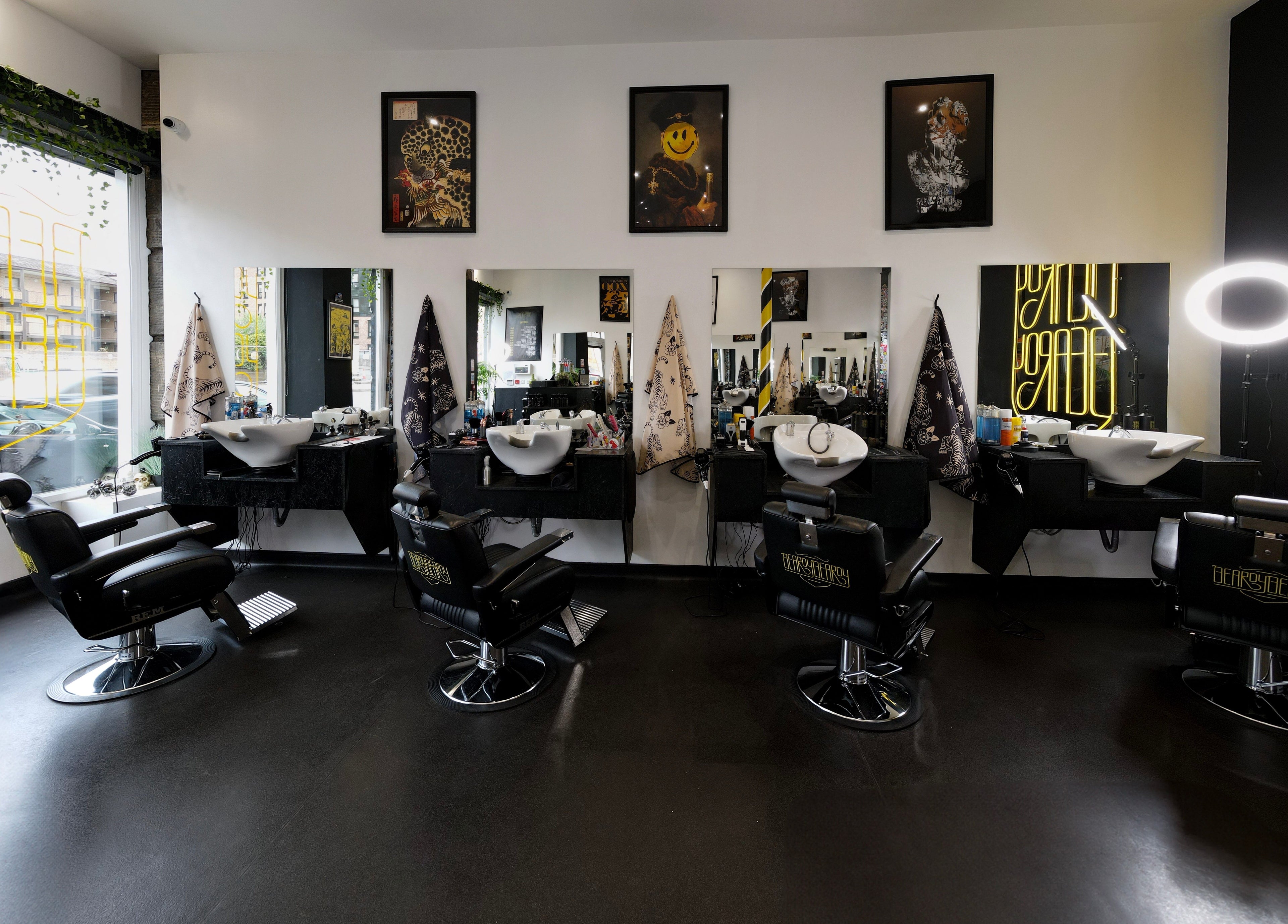 Interior of BeardyBeardyFinnieston with sleek chairs and mirrors in Glasgow, Scotland, GB.