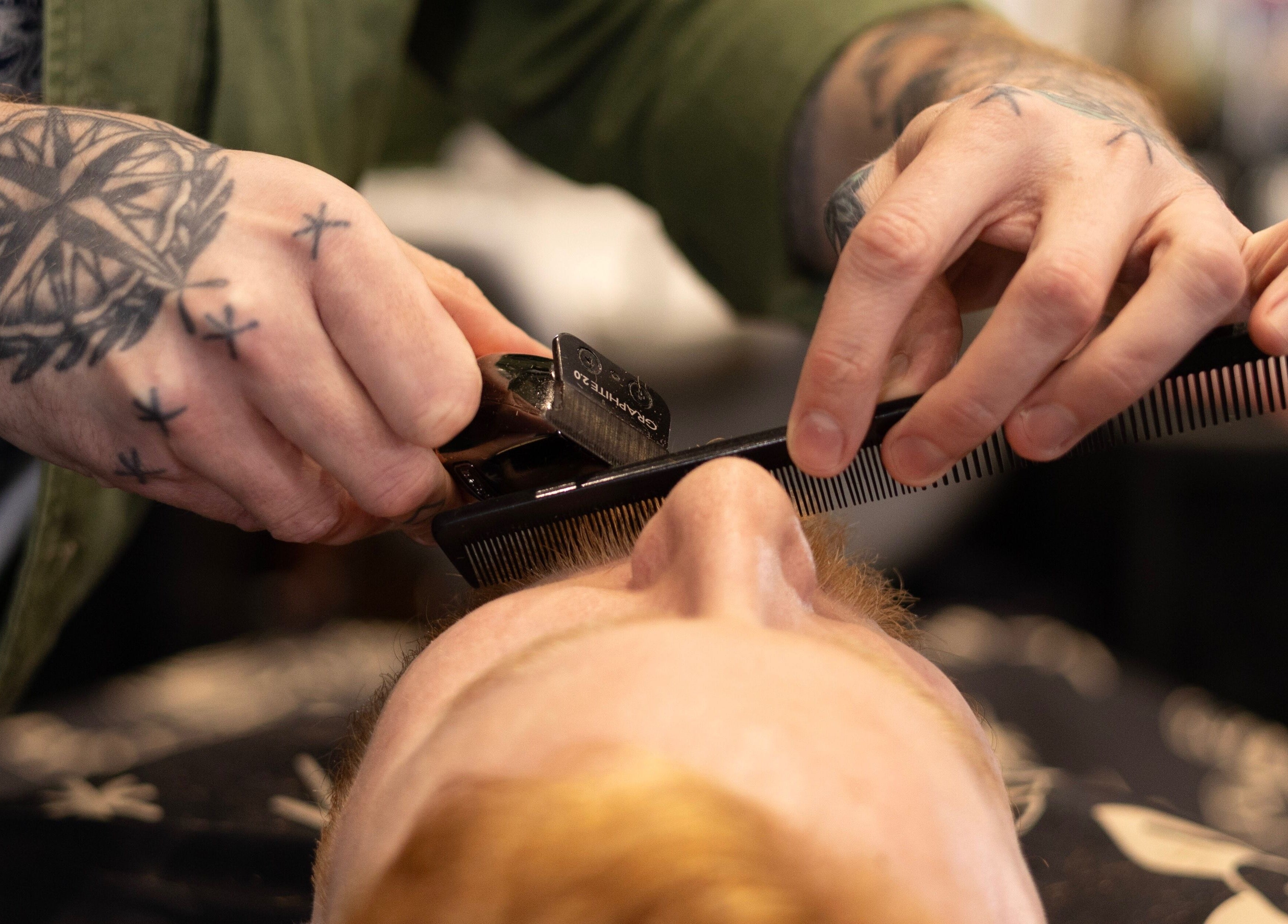 Expert beard trimming at BeardyBeardyFinnieston, Glasgow, Scotland, GB with precise clipper and comb technique.