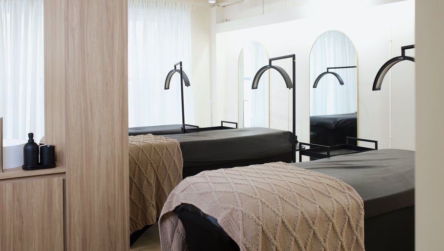 Massage beds in a tranquil setting at JL Beauty World, Toronto, Ontario, CA with soft blankets and elegant decor.
