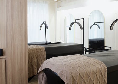Massage beds in a tranquil setting at JL Beauty World, Toronto, Ontario, CA with soft blankets and elegant decor.