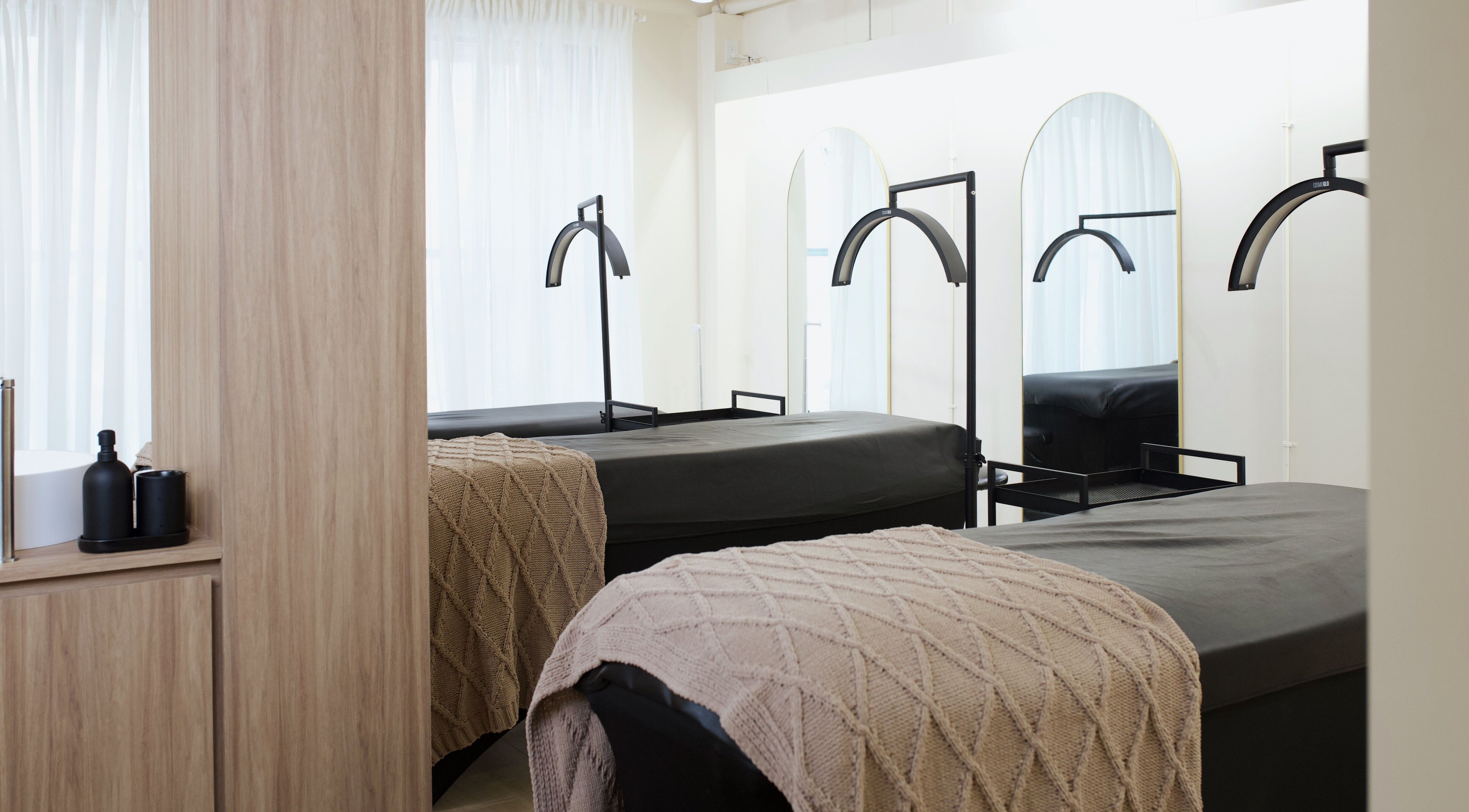 Massage beds in a tranquil setting at JL Beauty World, Toronto, Ontario, CA with soft blankets and elegant decor.