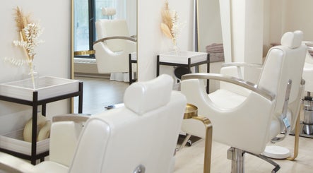 Elegant white salon chairs at JL Beauty World, Toronto, Ontario, CA, with refined decor for a luxurious experience.