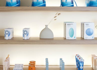 Elegant product display at JL Beauty World, Toronto, Ontario, CA showcasing skincare and wellness items on wooden shelves.