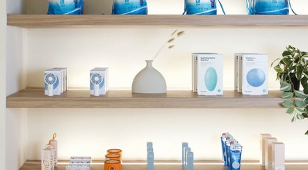 Elegant product display at JL Beauty World, Toronto, Ontario, CA showcasing skincare and wellness items on wooden shelves.