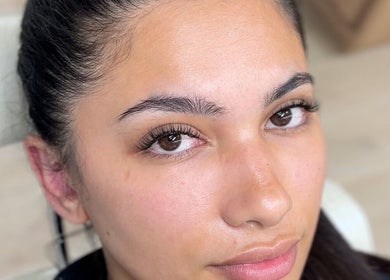 A close-up of a woman with glowing skin at JL Beauty World, Toronto, Ontario, CA.