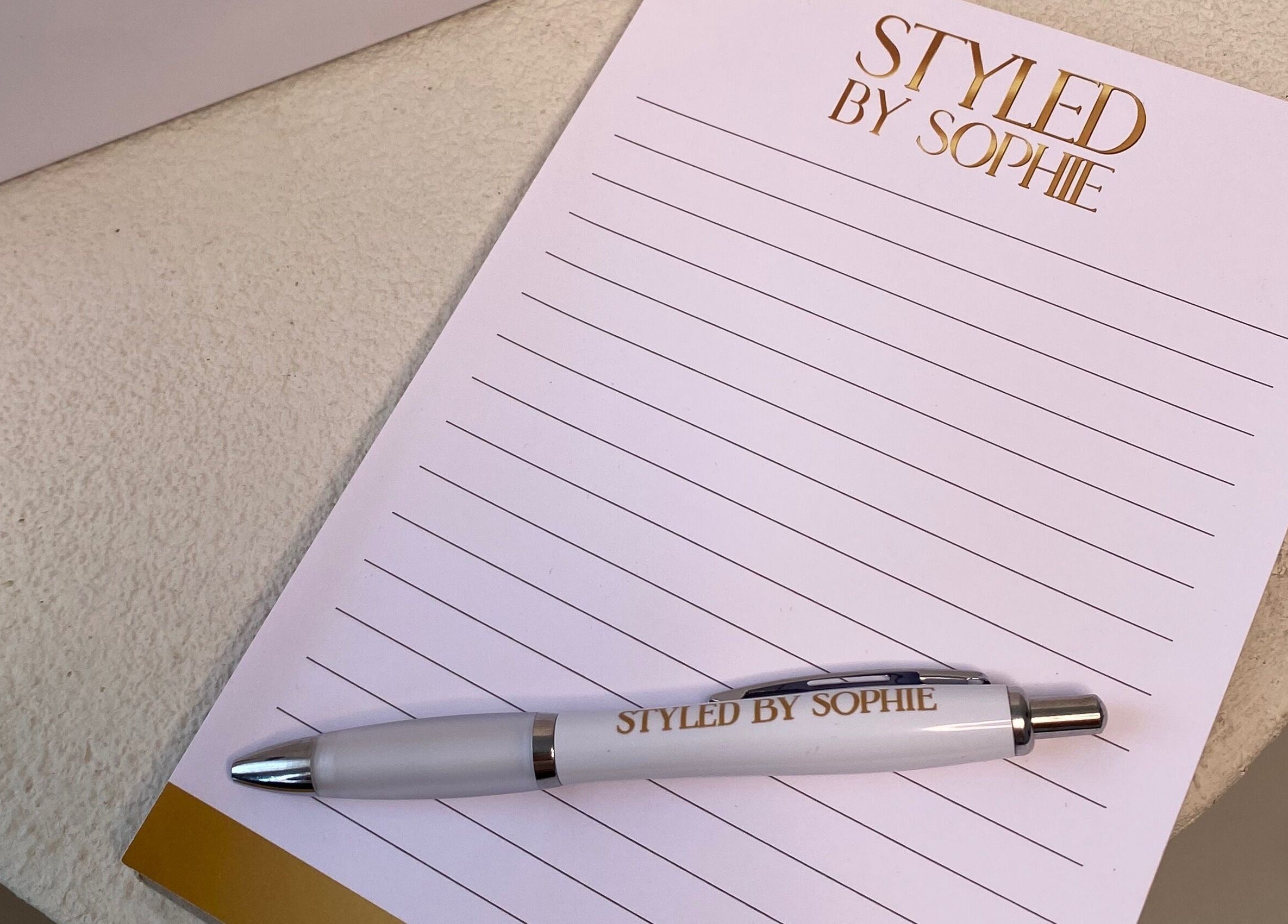 Styled By Sophie branded notepad and pen on a table in Leeds, England, GB.