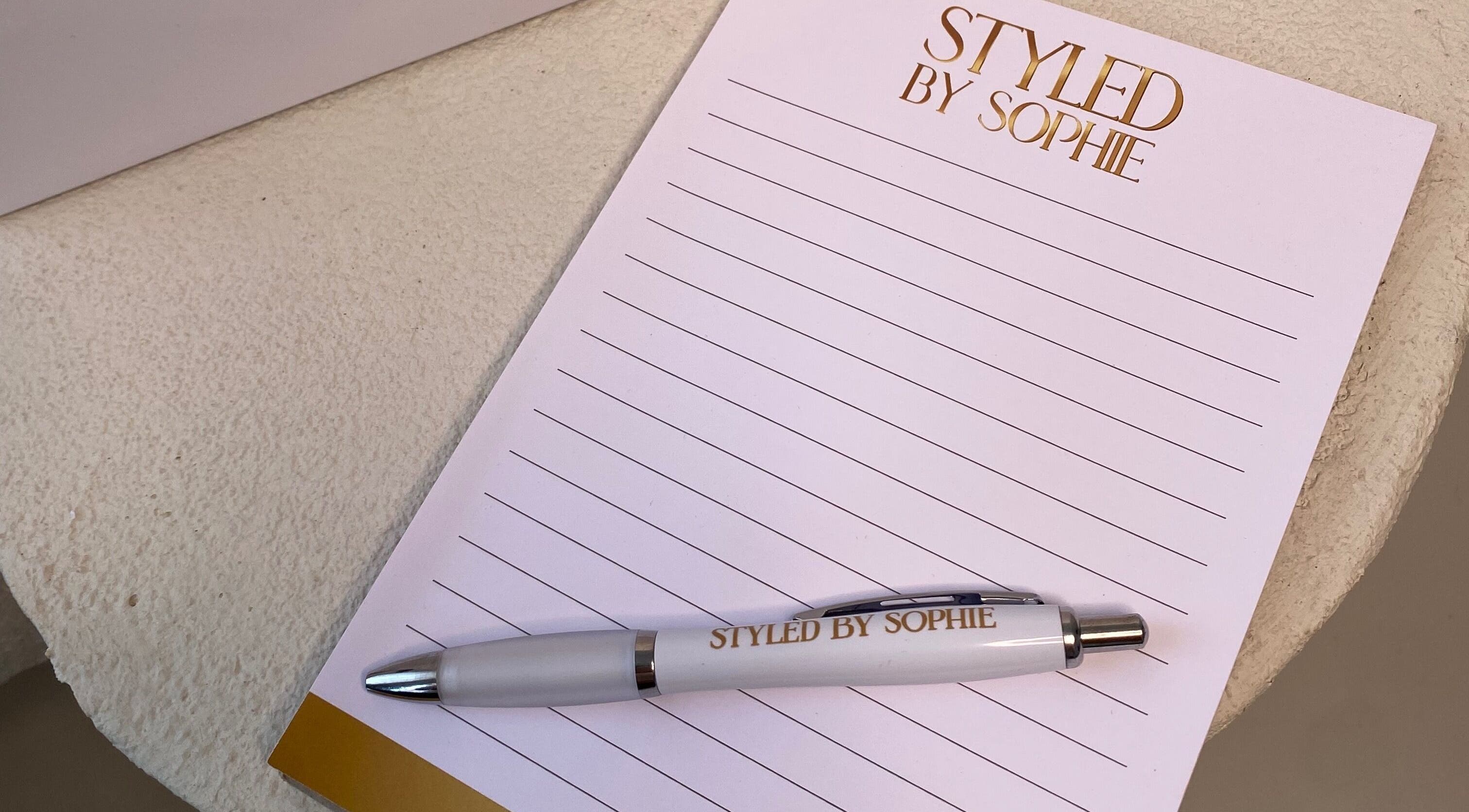 Styled By Sophie branded notepad and pen on a table in Leeds, England, GB.