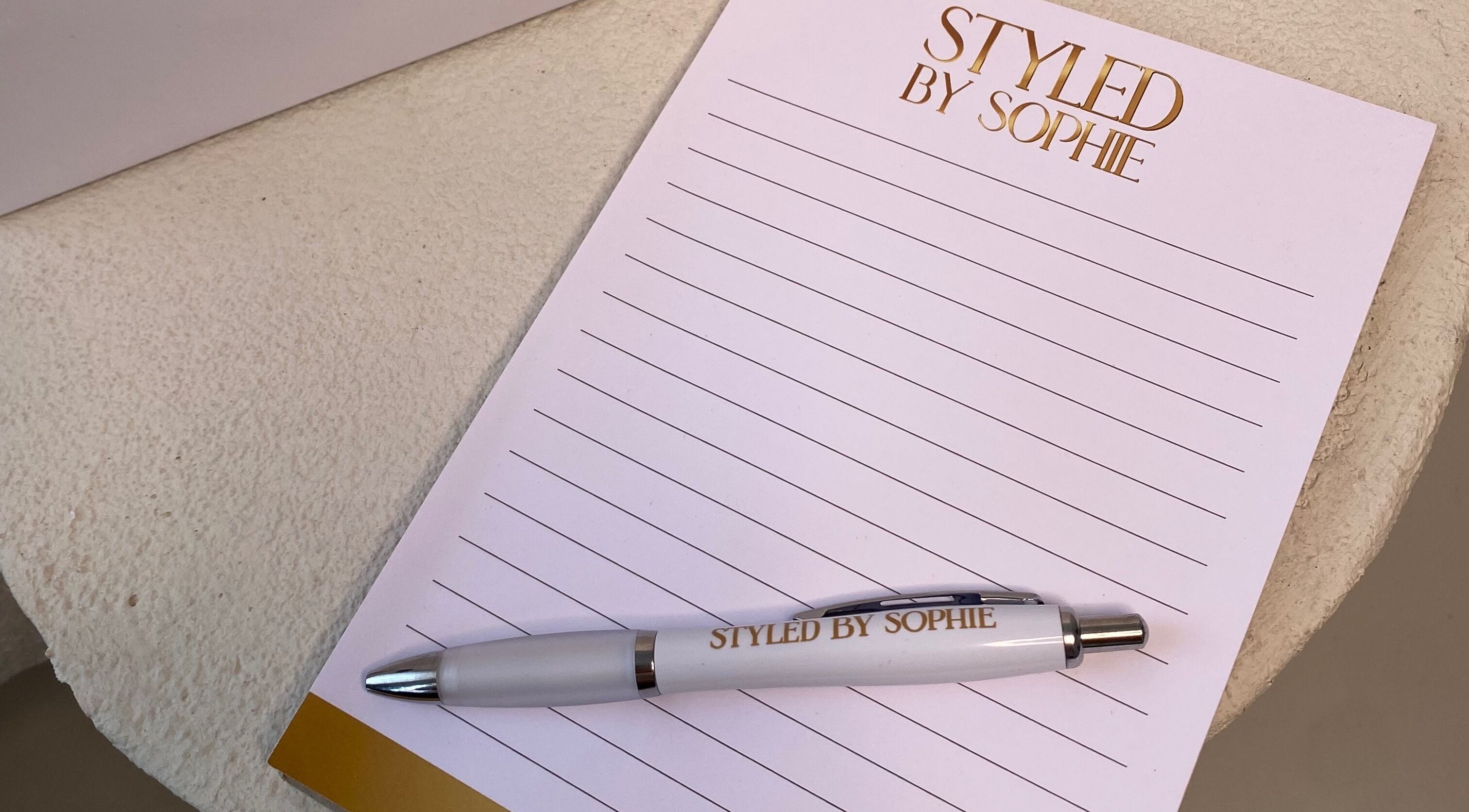 Styled By Sophie branded notepad and pen on a table in Leeds, England, GB.