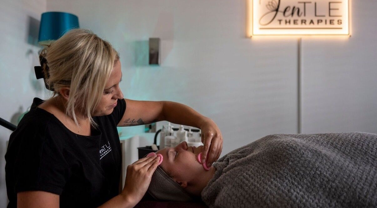 Therapist at Jentle Therapies in Portsmouth, England, providing a relaxing facial massage to a client.