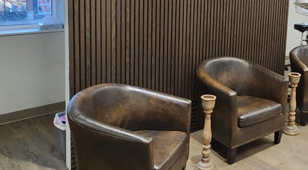 Cozy leather chairs in Capucci Salon, Toronto, Ontario, CA, creating a welcoming atmosphere.