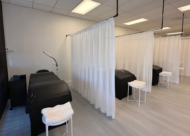 Elegant treatment area at Lashes Studio in San Jose, California, US, featuring cozy beds and white curtains.