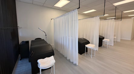 Elegant treatment area at Lashes Studio in San Jose, California, US, featuring cozy beds and white curtains.