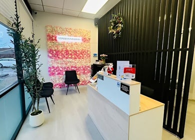 Elegant reception at Lashes Studio, San Jose, California, US, showcasing a floral wall and modern decor.