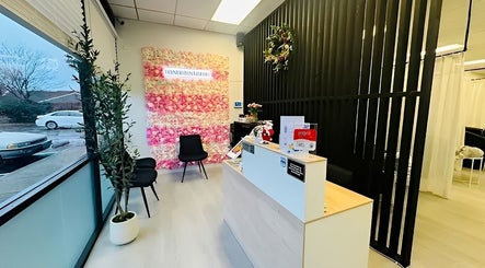 Elegant reception at Lashes Studio, San Jose, California, US, showcasing a floral wall and modern decor.