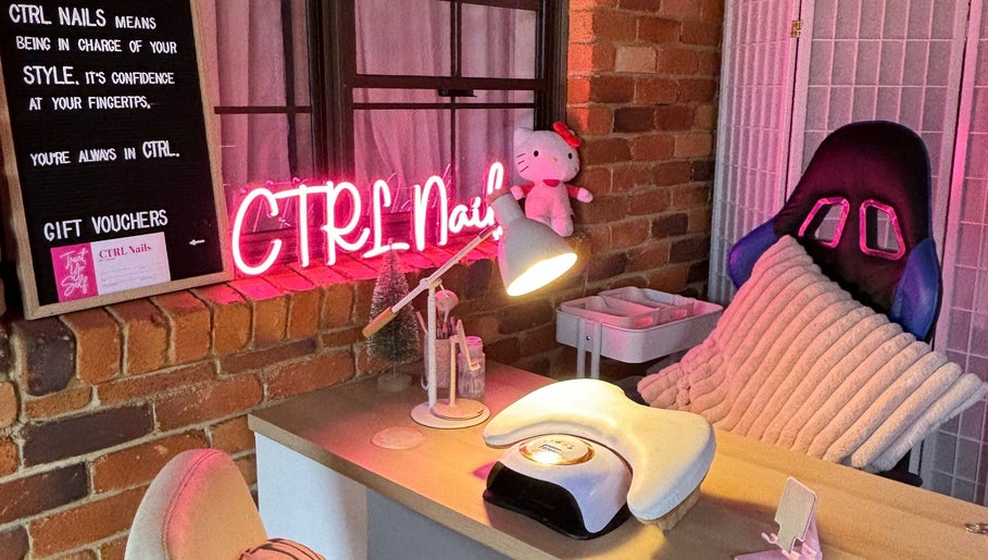 Cozy nail station at Ctrl Nails in Tinana, Queensland, AU, with neon sign and comfy chair.