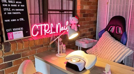 Cozy nail station at Ctrl Nails in Tinana, Queensland, AU, with neon sign and comfy chair.