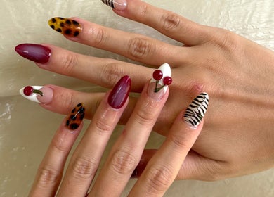 Stylish nail art featuring cherries and animal prints at Ctrl Nails, Tinana, Queensland, AU.
