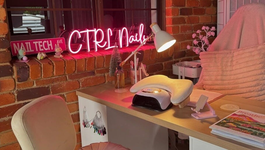 Inviting nail station at Ctrl Nails, Tinana, Queensland, AU with a neon sign and cozy decor.