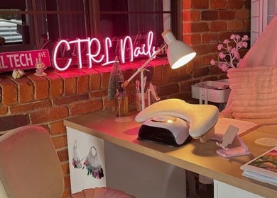 Inviting nail station at Ctrl Nails, Tinana, Queensland, AU with a neon sign and cozy decor.