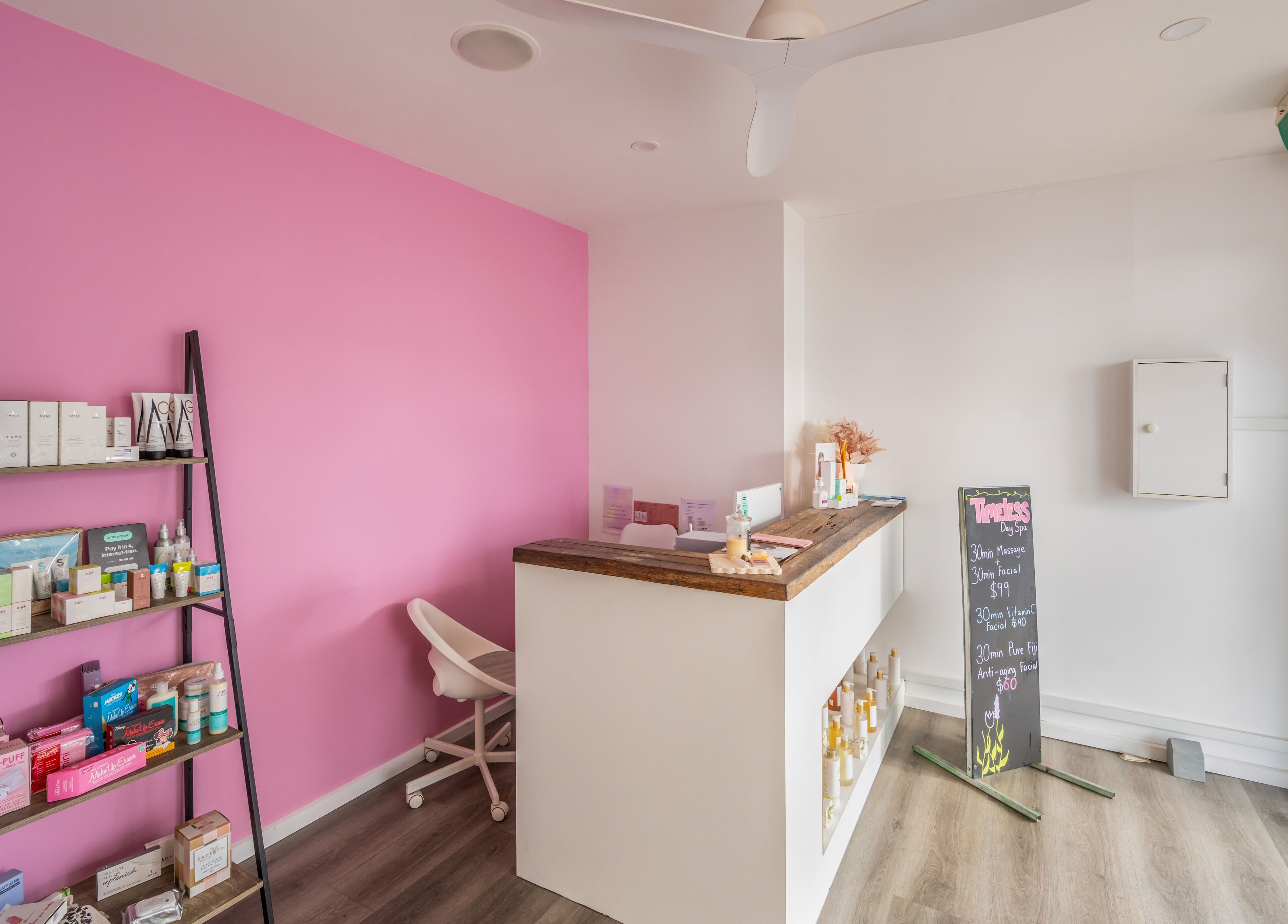 Timeless Day Spa reception area with bright pink wall and product display in Rye, VIC, AU.
