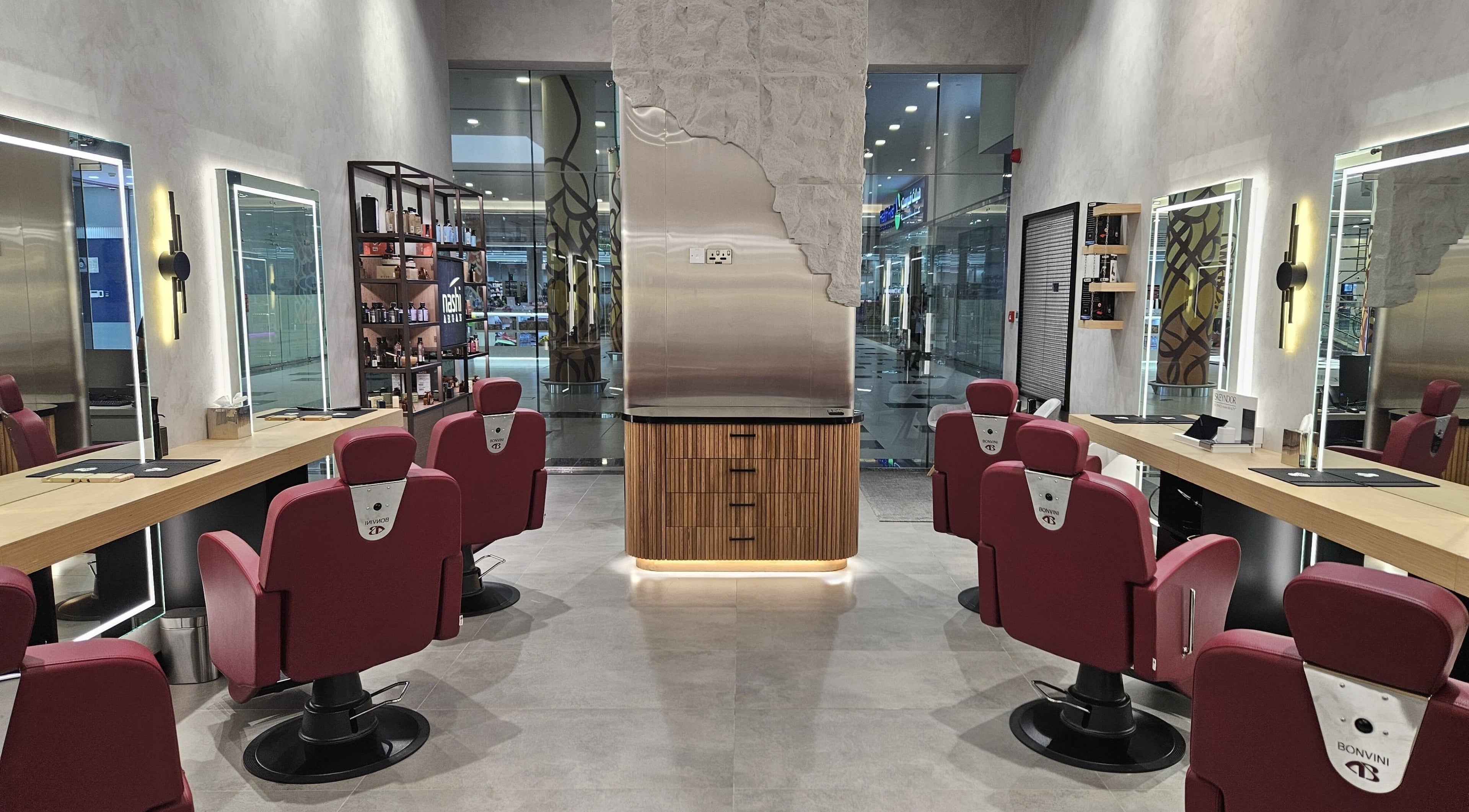 Interior of URS Gents Salon | Al Garhoud with red chairs and mirrors, located in Dubai, AE.