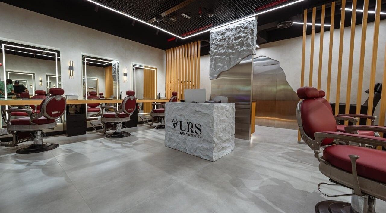 Chic interior of URS Gents Salon | Jumeirah in Dubai, AE showcasing sleek barbershop chairs and contemporary design.