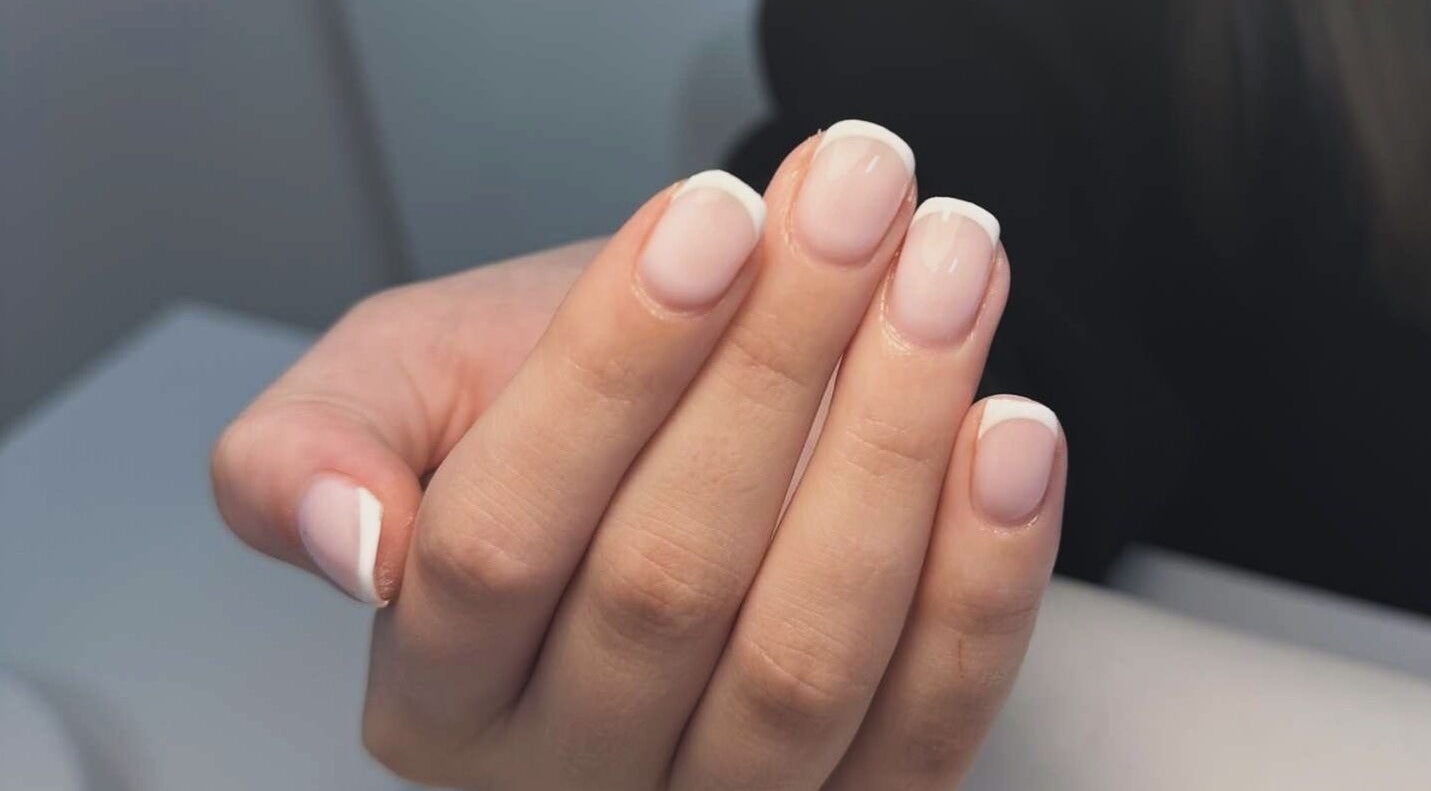 A fresh French manicure at GET GLAM studio in Blaenavon, Wales, GB, showcasing neat and polished nails.