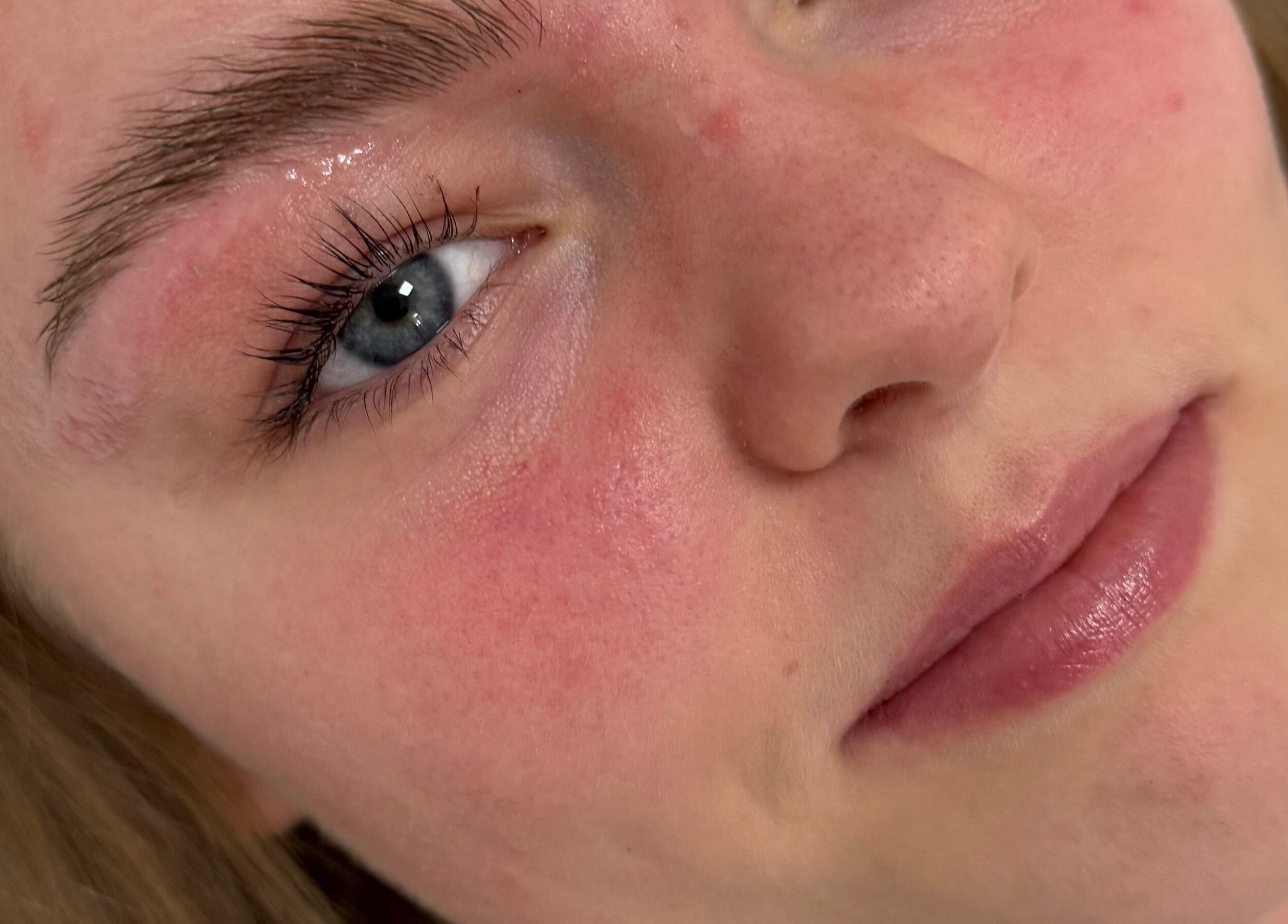 Close-up of a client's radiant skin post-treatment at GET GLAM studio, Blaenavon, Wales, GB.