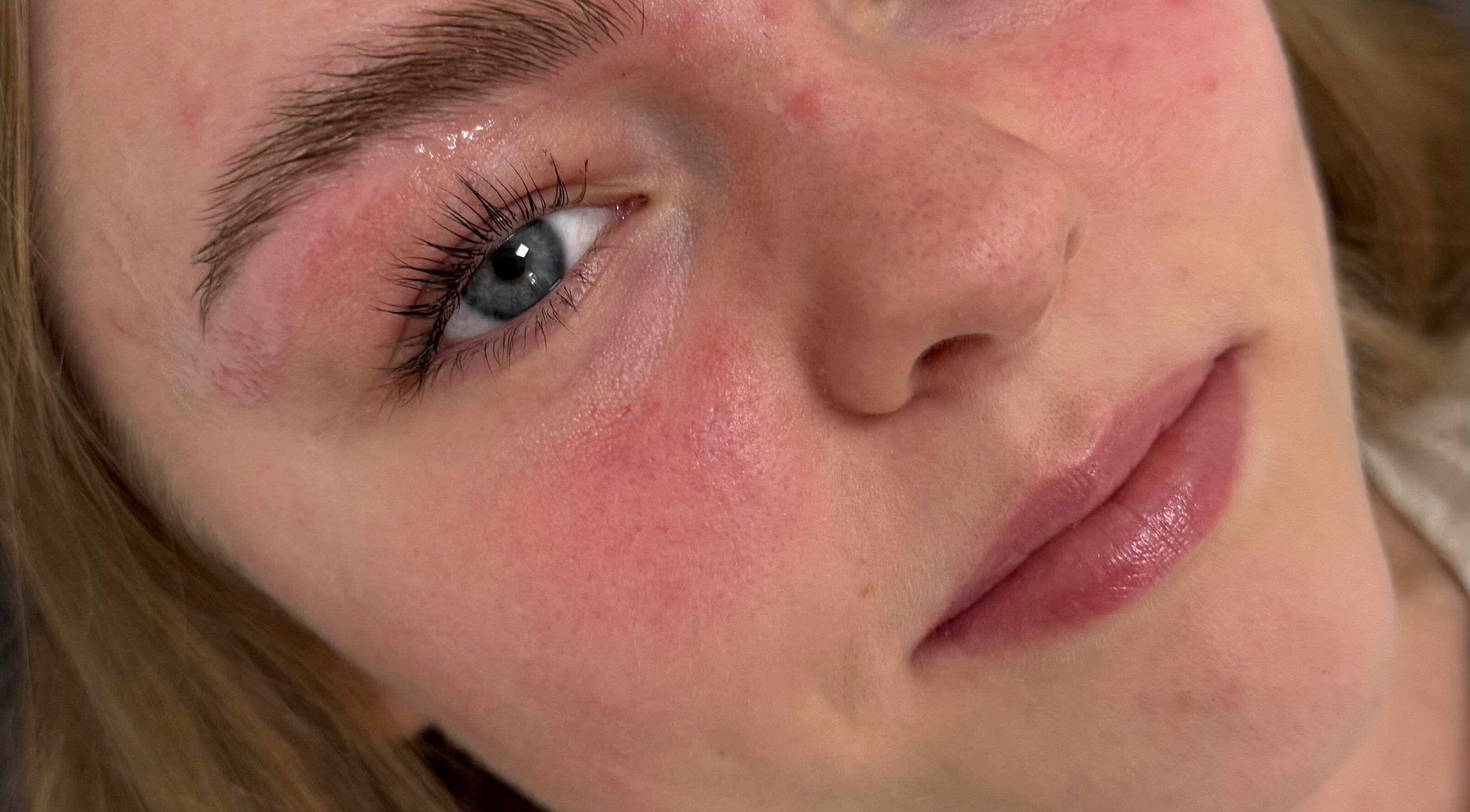Close-up of a client's radiant skin post-treatment at GET GLAM studio, Blaenavon, Wales, GB.