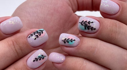 Chic Nail Studio in Arlington, Virginia, US showcases elegant leaf nail art with pastel hues and intricate design.