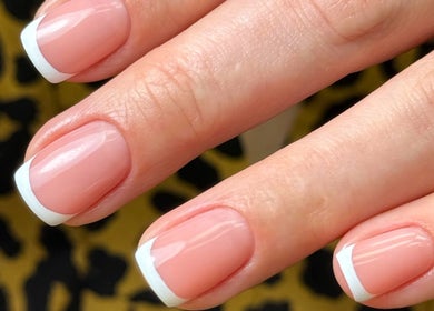 Elegant French manicure at Chic Nail Studio, Arlington, Virginia, US, showcasing glossy finish and precision.