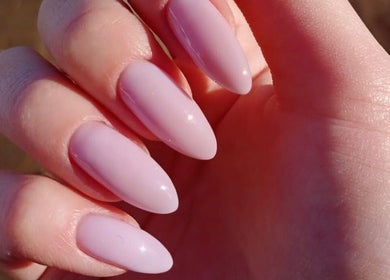 Elegant almond-shaped nails at Chic Nail Studio in Arlington, Virginia, US with soft pink polish.