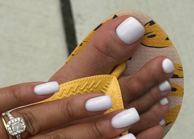 White manicure and pedicure at Chic Nail Studio, Arlington, Virginia, US, showcasing ring and stylish sandals.